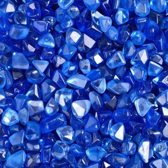 A collection of smooth, vibrant blue glass pebbles, glistening under soft light, showcasing various shades of blue and unique shapes, perfect for decor.