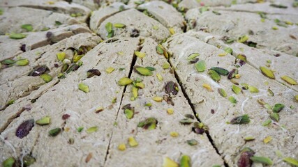 Close-up of pistachio halva. Gluten-free oriental sweets. Lactose-free. Market, oriental food festival. Side view.