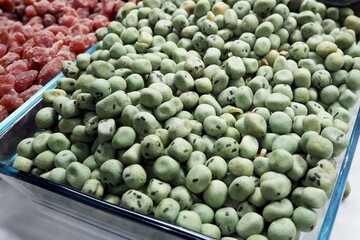 Fried wasabi peas with a spicy flavor, at the market, Eastern food
