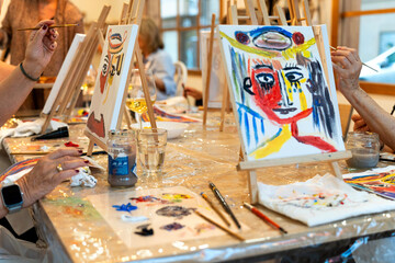 Art & Wine workshop. People enjoying painting and wine workshop activity