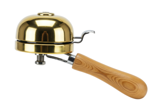 Isolated brass bicycle bell with a wooden handle for vintage cycling. Decorative retro bike bell