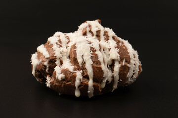 Profiteroles with coconut cream on a black background.