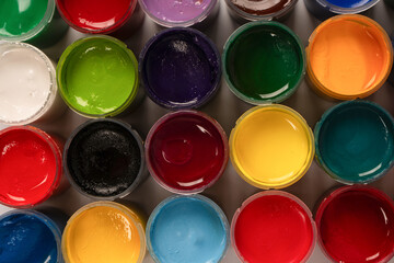 Fototapeta premium Gouache colorful paints set. Jars of gouache paint isolated on a white background.