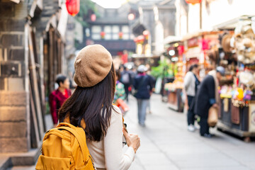 Young female tourist walking at Jinli Ancient Street in Chengdu, China