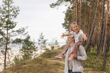 Happy family bonding outdoors at the forest near the beach