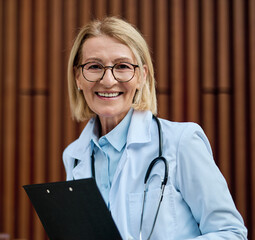 Portrait of a mature female woman doctor or nurse and  health care worker holding a cup of coffee...