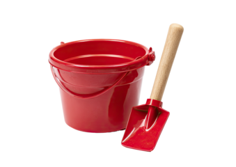 A red plastic bucket with a handle and a matching red spade with a wooden handle on a black background