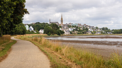 View of the village of Pont-Croix and the Goyen River at low tide, under a cloudy sky, in the Finistere department of Brittany, France