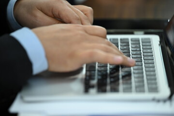 man typing on a laptop