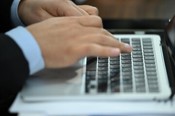 businessman typing on a laptop