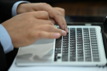 businessman typing on a laptop