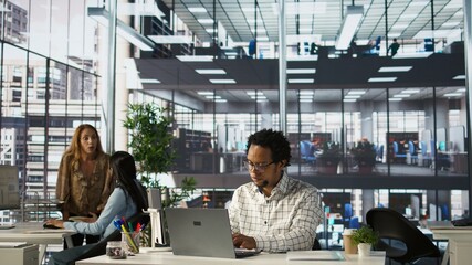 Skilled businessman at his office desk working on report writing, data analysis and deadline...
