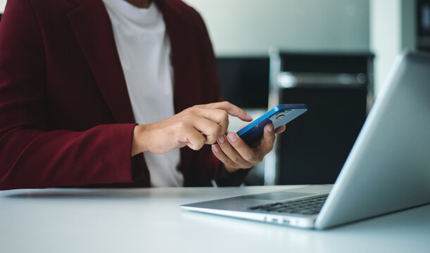 businessman using a stylus with smart phone in office. Concept of smart technology, remote work