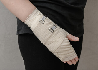 A hand wrapped in a bandage, a splint after a wrist injury