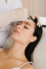 Forehead Injection close-up. Forehead botulinum toxin injection smooths fine lines and relaxes...
