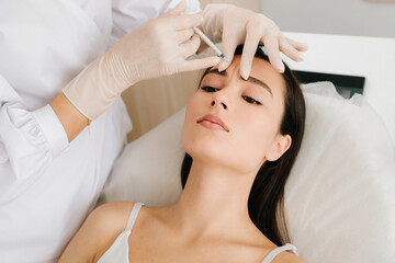 Glabellar Botulinum Toxin Injection close-up. Anti-wrinkle therapy using botulinum toxin smooths...
