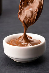 Cream chocolate in a bowl on a black background