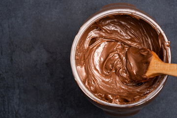 Cream chocolate in a bowl on a black background