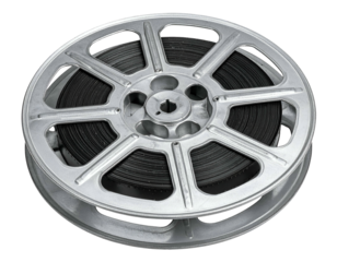 A silver film reel, filled with black film, sits against a dark background