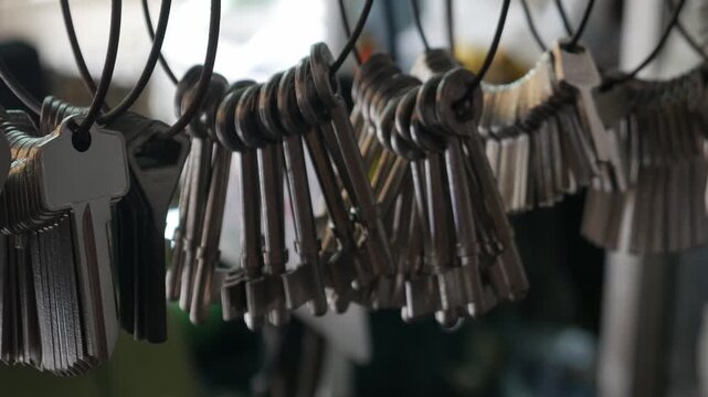 Multiple Duplicate Keys Hanging on Wire Rings at Locksmith Shop - Key Cutting and Duplication Service Business