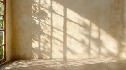 Soft light casts shadows on textured wall, creating serene atmosphere in room