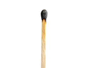A single, partially burned wooden match against a stark, black background