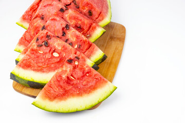 Red sliced watermelon. Close-up of watermelon slices against a white background.