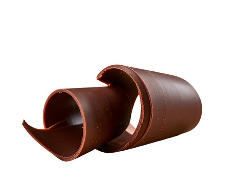A curled chocolate decoration sits against a dark backdrop, showing rich details