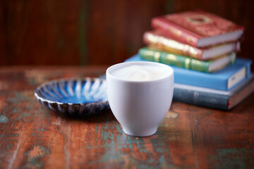 Cappuccino on dark wooden background. Soft focus. Close up	