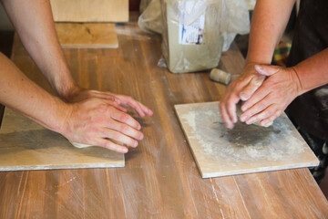 Hands Kneading Clay on Wooden Table in Pottery Workshop