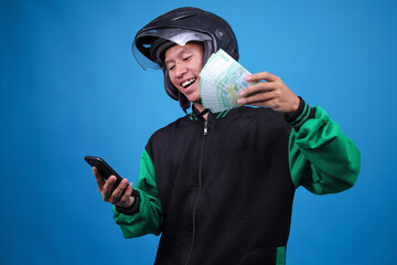Excited Delivery Driver Celebrates Earning Cash While Checking Smartphone