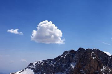 Blue sky with clouds and snow rocks