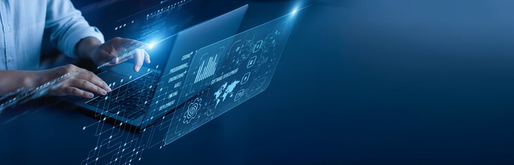 Software Development network connection concept. Programmer hand working on a laptop computer with a graphical source code framework deployment version control debugging interface.
