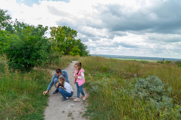 Father and children have fun, laugh and enjoy nature outdoors.