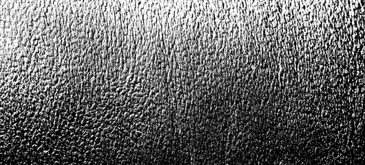 High-contrast cracked and wrinkled leather surface texture with deep shadows, isolated on a...