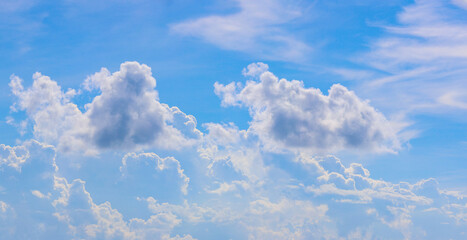 Vast blue sky decorated with fluffy cumulus clouds. Sky background