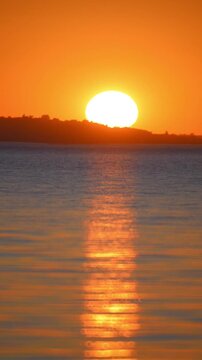 Sunset on the Dnieper River, Kaniv Reservoir, horizon and water in orange light.