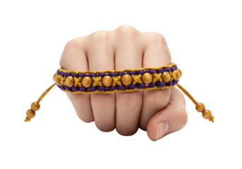 Isolated hand wearing braided bracelet with wooden beads and purple and yellow decorative design