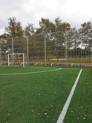 Football field with protective fencing during overcast weather