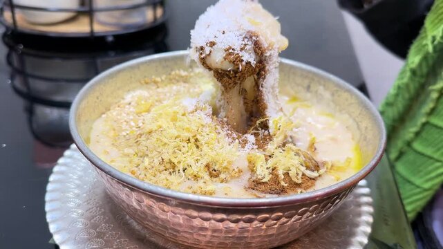 Halim Persian cuisine shredded pulled beef stew iftar Ramadhan meal garnished and sesame cinnamon spices served in copper bowl delicious healthy dish for breakfast or dinner Ramadan Tehran street food