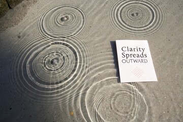 White card with message next to calming water ripple patterns