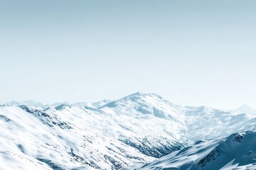 Snow-covered mountain range landscape aerial view in winter with blue sky; panoramic vista of Alps peaks and valleys