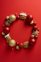 Vertical circle of Christmas treats and ornaments forming a wreath with copyspace and gingerbread...