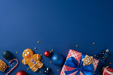 A cheerful holiday scene featuring gingerbread cookies, shiny ornaments, candy canes, and neatly...