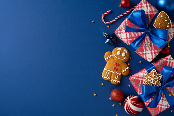 Festive scene featuring wrapped gifts, cookies, and ornaments arranged on a blue backdrop,...