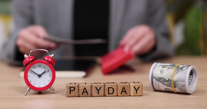 Counting cash and checking time reveals the excitement of payday celebrations in a cozy workspace
