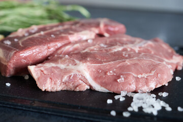Close-up of beef steaks with sea salt. Marbled beef.