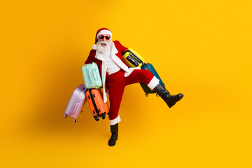 Santa Claus carrying colorful suitcases on a vibrant yellow background celebrating Christmas travel with joyful holiday spirit