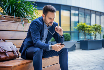 Worried businessman checking mail from his client via tablet. Business, lifestyle concept