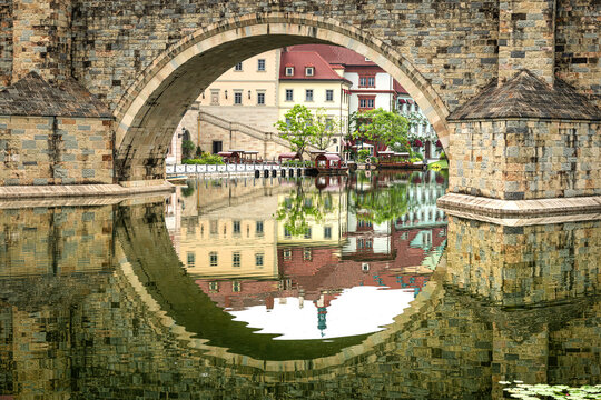 Tranquil waters reflect charming buildings by Songshan Lake